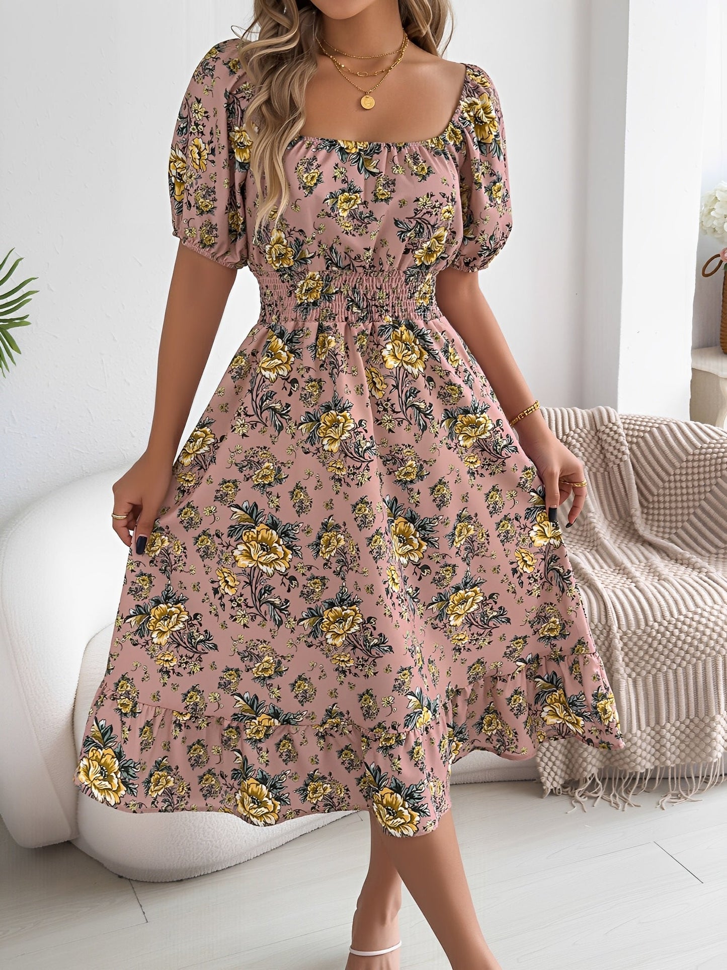 Pink - Woman wearing a floral print off-the-shoulder midi dress with a smocked waist and short puff sleeves, holding a woven straw bag