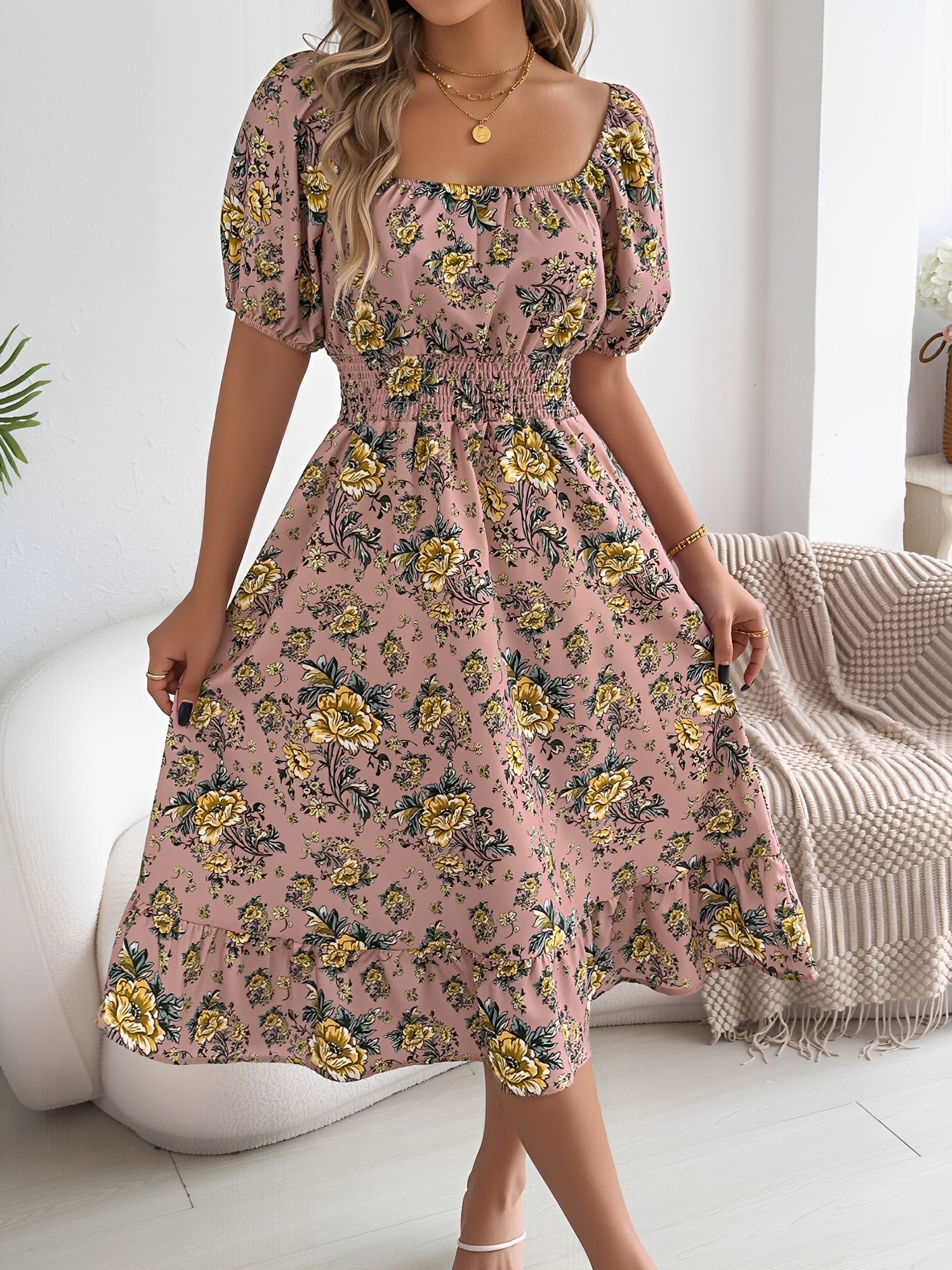 Pink - Woman wearing a floral print off-the-shoulder midi dress with a smocked waist and short puff sleeves, holding a woven straw bag