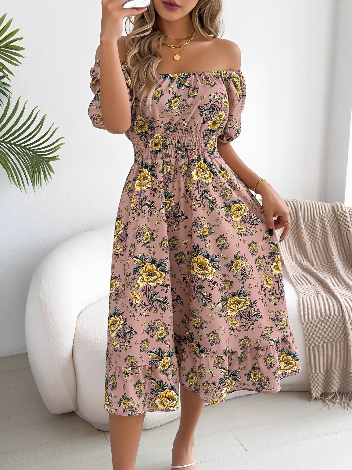 Pink - Woman wearing a floral print off-the-shoulder midi dress with a smocked waist and short puff sleeves, holding a woven straw bag