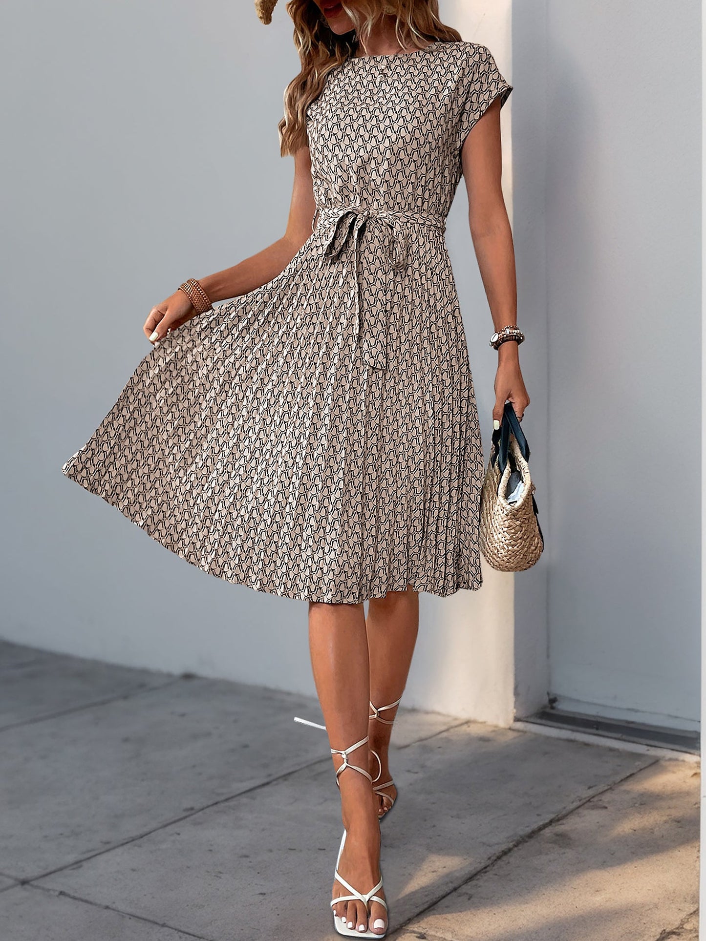 Khaki - Woman wearing a woven floral cap-sleeve midi dress with a self-tie waist and pleated skirt.