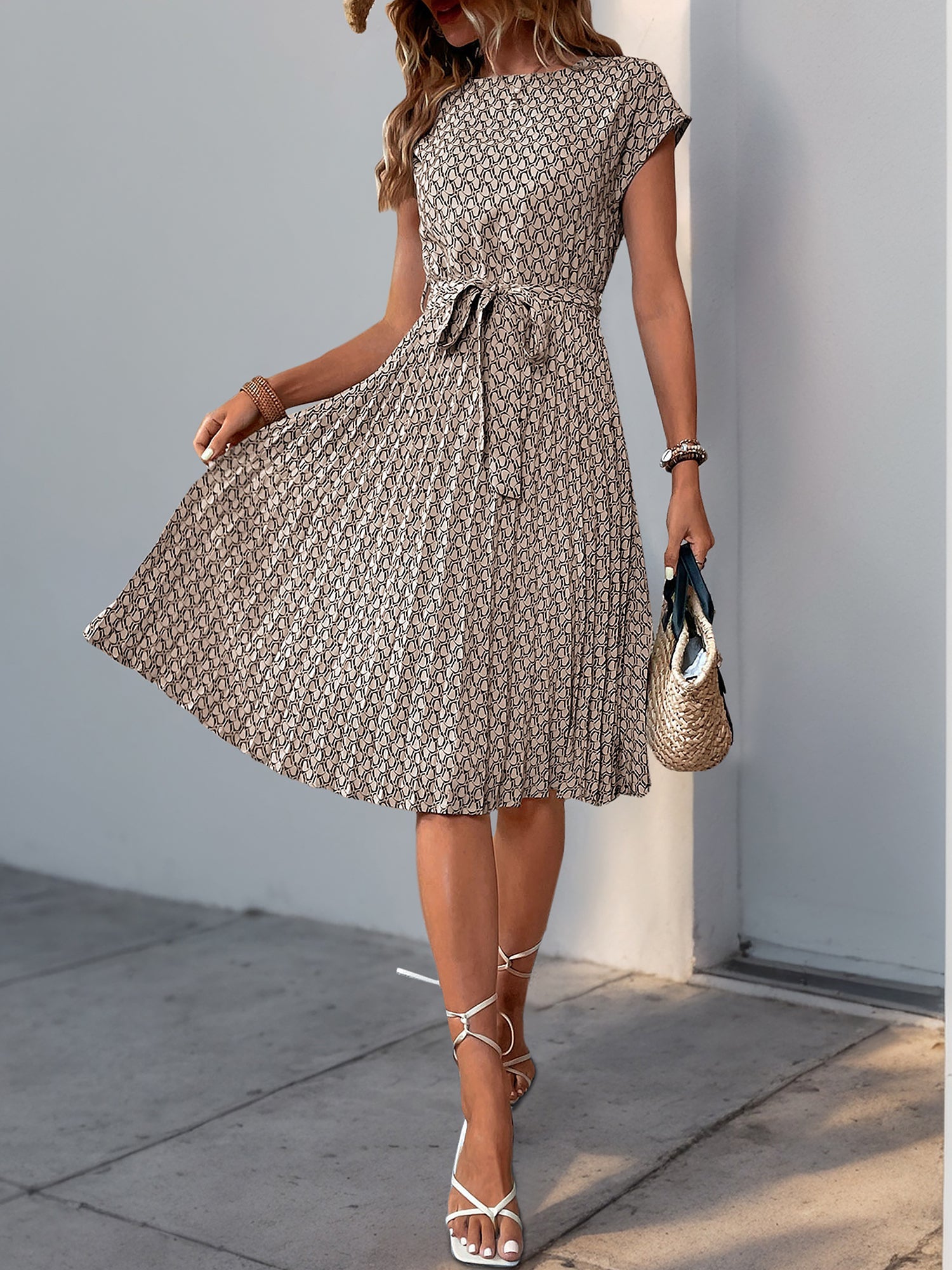 Khaki - Woman wearing a woven floral cap-sleeve midi dress with a self-tie waist and pleated skirt.