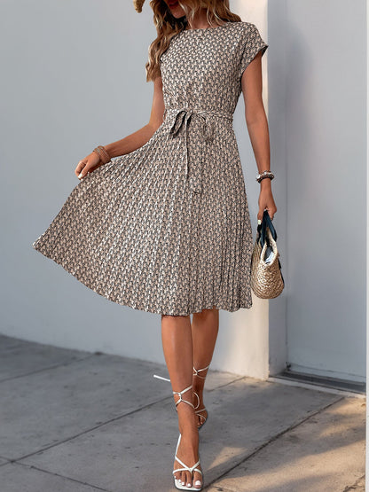 Khaki - Woman wearing a woven floral cap-sleeve midi dress with a self-tie waist and pleated skirt.