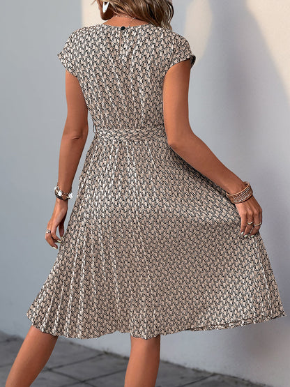 Khaki - Woman wearing a woven floral cap-sleeve midi dress with a self-tie waist and pleated skirt.