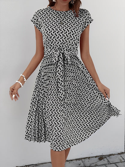 Black - Woman wearing a woven floral cap-sleeve midi dress with a self-tie waist and pleated skirt.