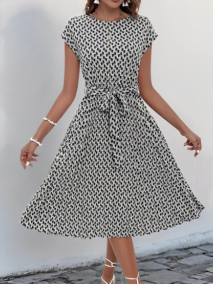 Black - Woman wearing a woven floral cap-sleeve midi dress with a self-tie waist and pleated skirt.