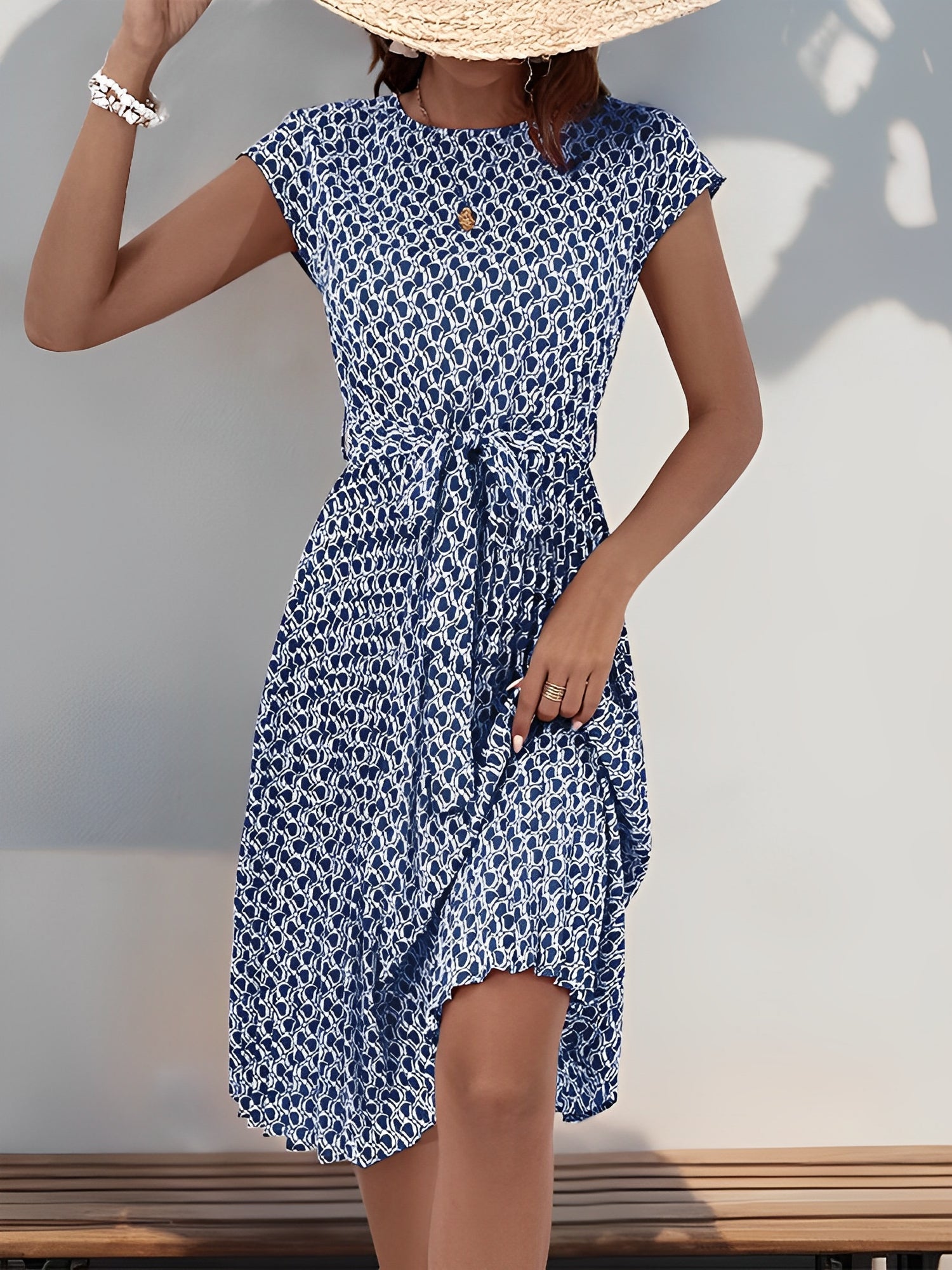 Navy Blue - Woman wearing a woven floral cap-sleeve midi dress with a self-tie waist and pleated skirt.