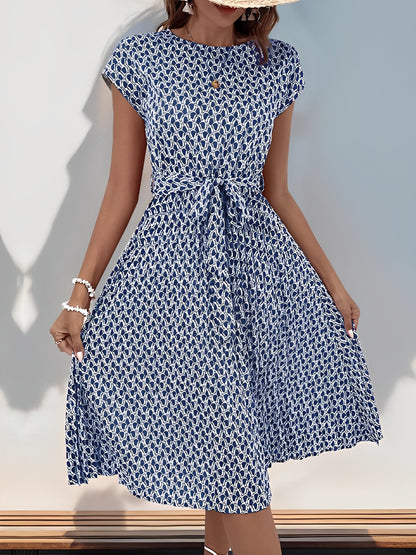 Navy Blue - Woman wearing a woven floral cap-sleeve midi dress with a self-tie waist and pleated skirt.