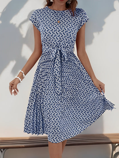 Navy Blue - Woman wearing a woven floral cap-sleeve midi dress with a self-tie waist and pleated skirt.