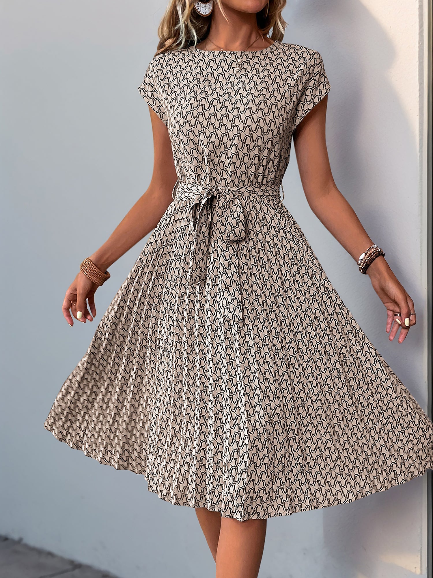Khaki - Woman wearing a woven floral cap-sleeve midi dress with a self-tie waist and pleated skirt.
