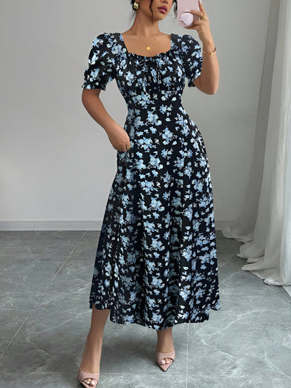 Blue - Woman wearing a floral print midaxi dress with puff sleeves, a square neckline, and a ruched bust detail.