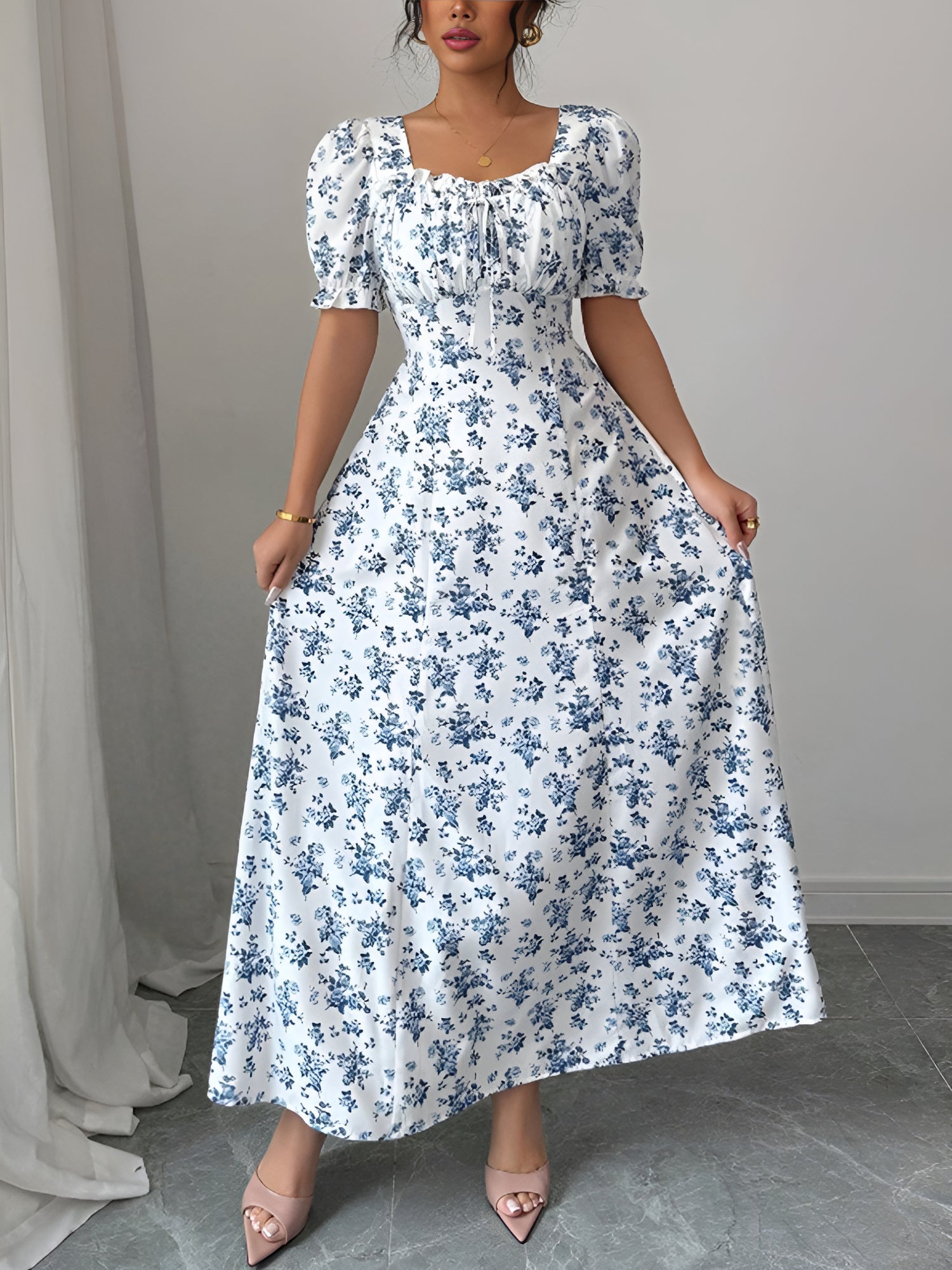 White - Woman wearing a floral print midaxi dress with puff sleeves, a square neckline, and a ruched bust detail.