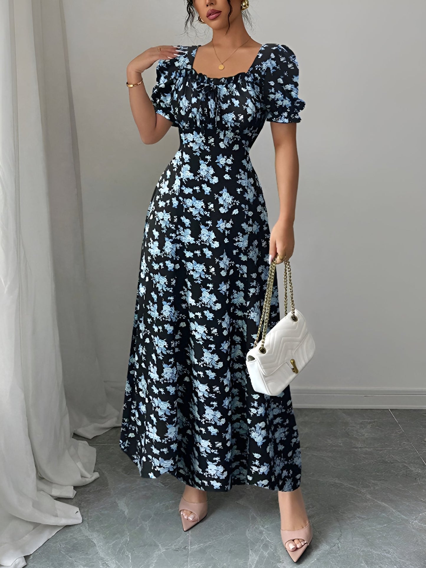 Blue - Woman wearing a floral print midaxi dress with puff sleeves, a square neckline, and a ruched bust detail.