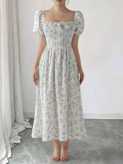 Blue - Woman wearing a woven floral square-neck midi dress with short puff sleeves and a shirred bodice
