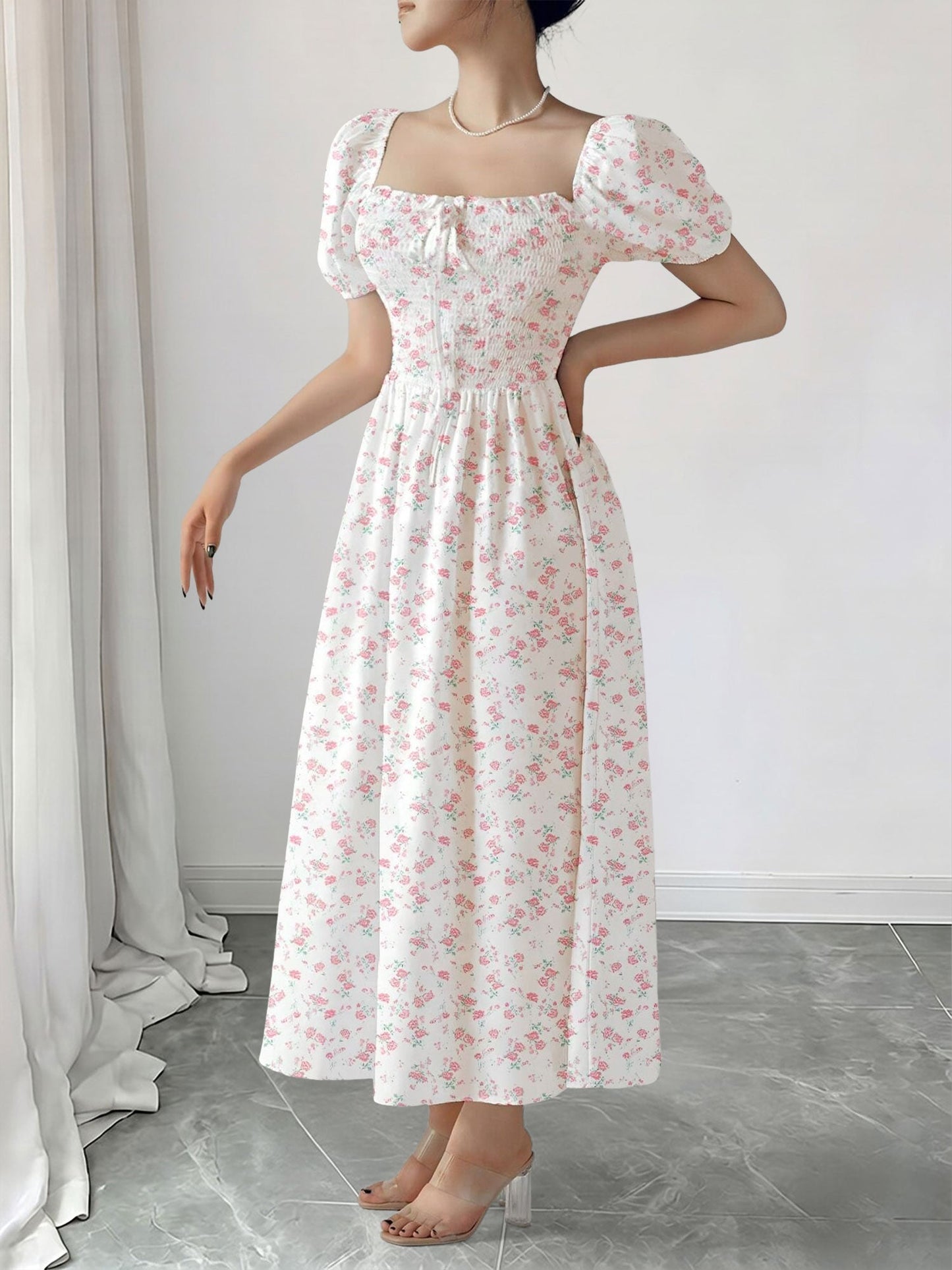 Light Pink - Woman wearing a woven floral square-neck midi dress with short puff sleeves and a shirred bodice