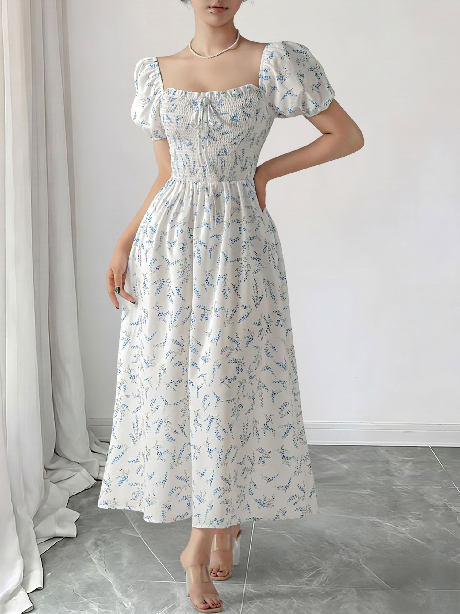 Blue - Woman wearing a woven floral square-neck midi dress with short puff sleeves and a shirred bodice