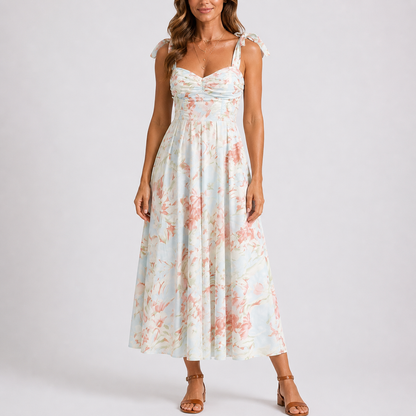 Floral - Model wearing a woven floral midi dress featuring a sweetheart neckline, tie-shoulder straps, and a flowing A-line skirt.