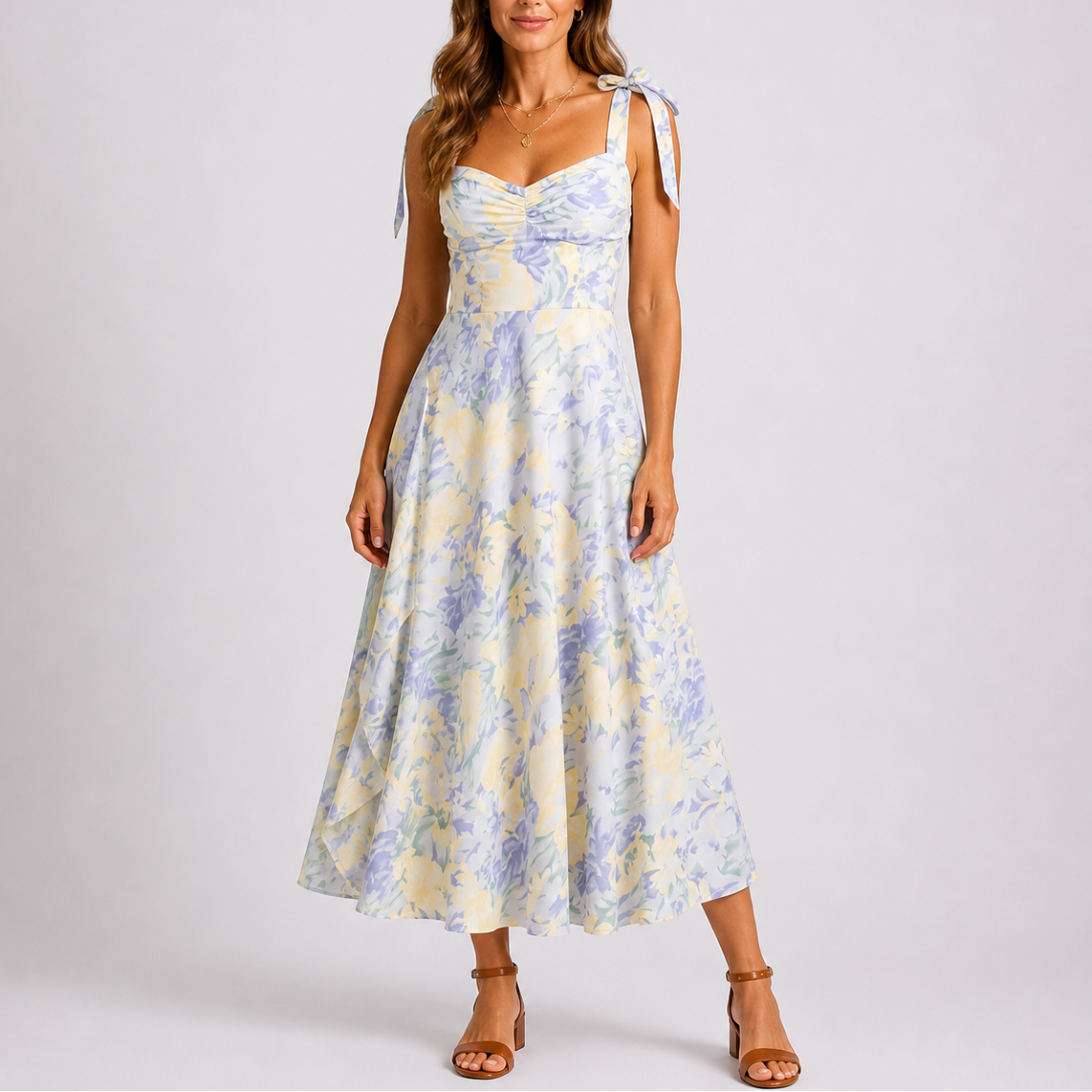 Floral White - Model wearing a woven floral midi dress featuring a sweetheart neckline, tie-shoulder straps, and a flowing A-line skirt.