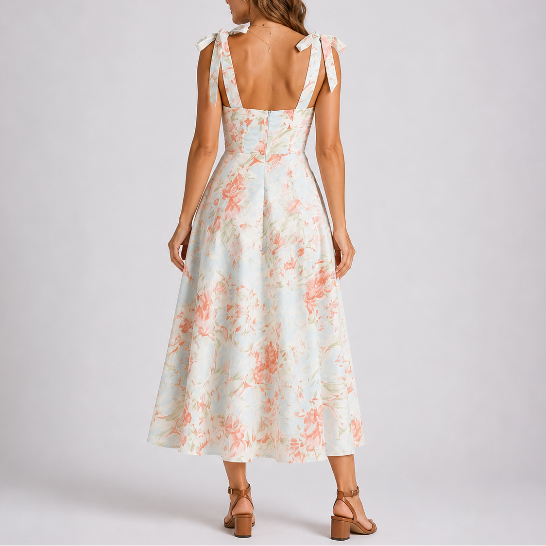 Floral White - Model wearing a woven floral midi dress featuring a sweetheart neckline, tie-shoulder straps, and a flowing A-line skirt.