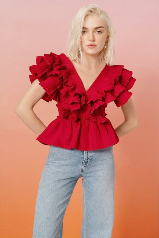 Women's bright red peplum blouse featuring dramatic tiered shoulder ruffles and a deep V-neckline.