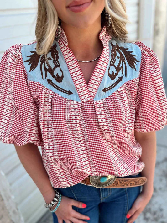 Women's relaxed fit blouse in a red and white gingham pattern, featuring a contrasting light blue V-neck yoke with brown embroidered horse motifs and short puff sleeves.