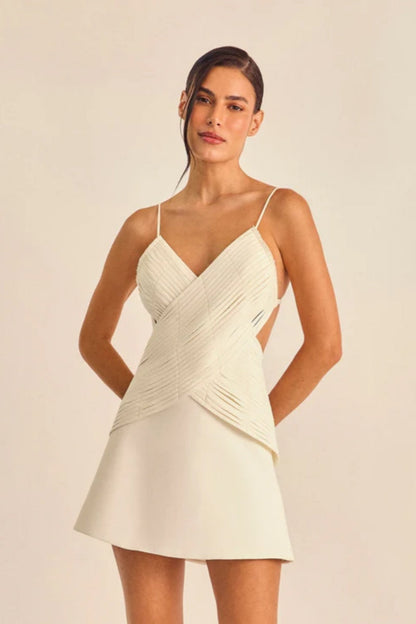 White - Women's cream A-line mini dress featuring a unique criss-cross wrapped bodice with textured banding, a V-neckline, delicate spaghetti straps, and side waist cut-outs.