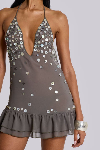 Grey - Women's grey halter neck mini dress featuring a deep plunging neckline, scattered button embellishments, an open back, and a tiered ruffle hem.