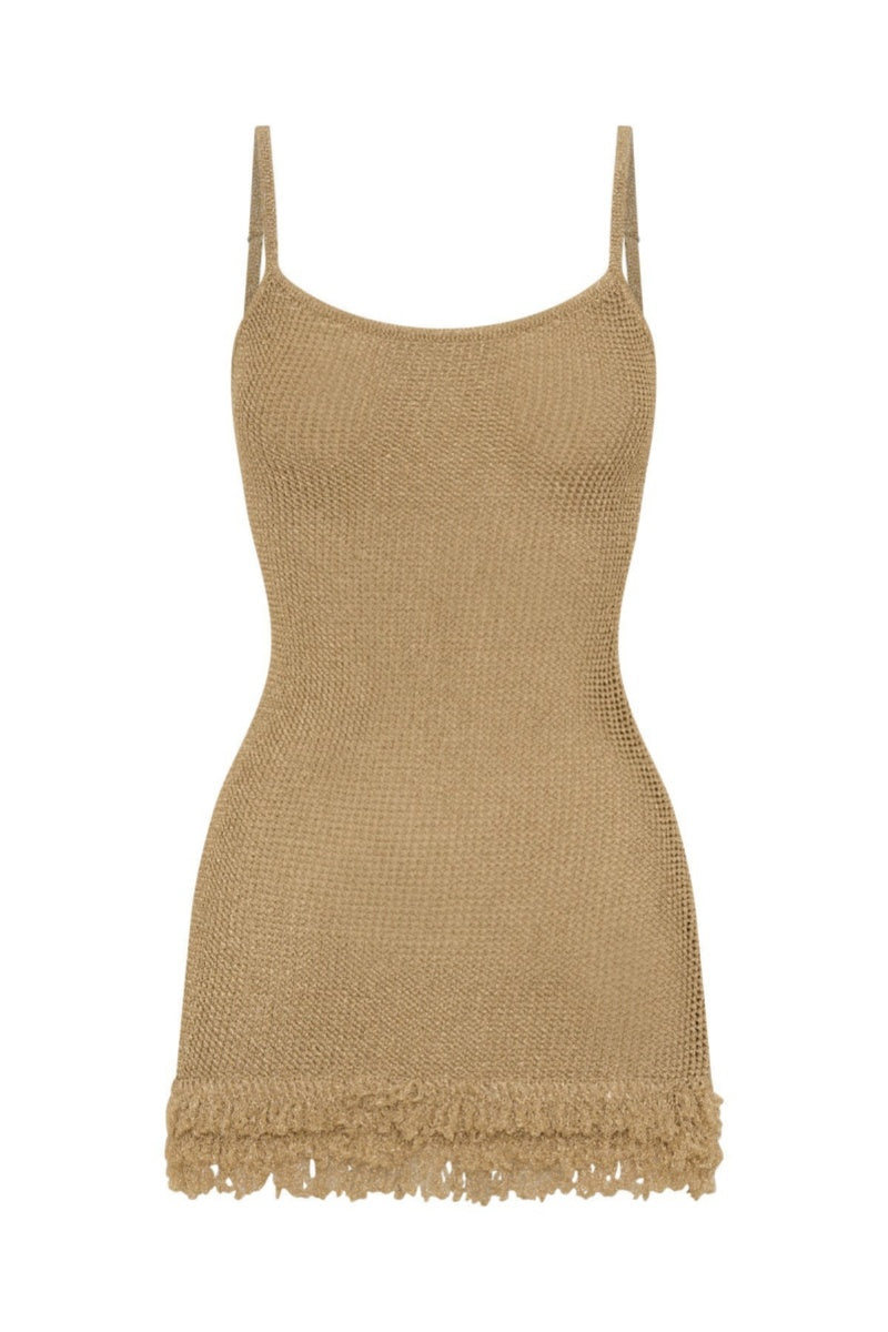 Khaki - A woman standing on a sandy beach at sunset, wearing a light green, semi-sheer open-knit mini dress featuring spaghetti straps and a fringed hem.