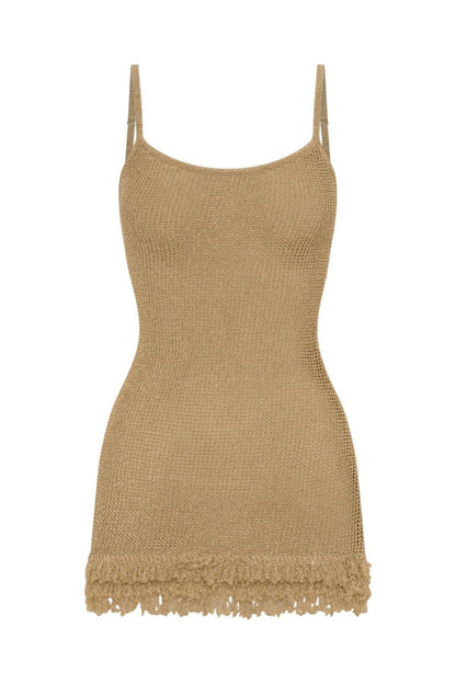 Khaki - A woman standing on a sandy beach at sunset, wearing a light green, semi-sheer open-knit mini dress featuring spaghetti straps and a fringed hem.