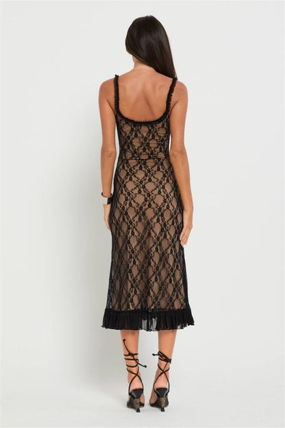 Black - A woman modelling a fitted midi dress featuring a black floral lace overlay over a nude lining, complete with ruffled straps, a corset-style bodice, and a frilled hem.