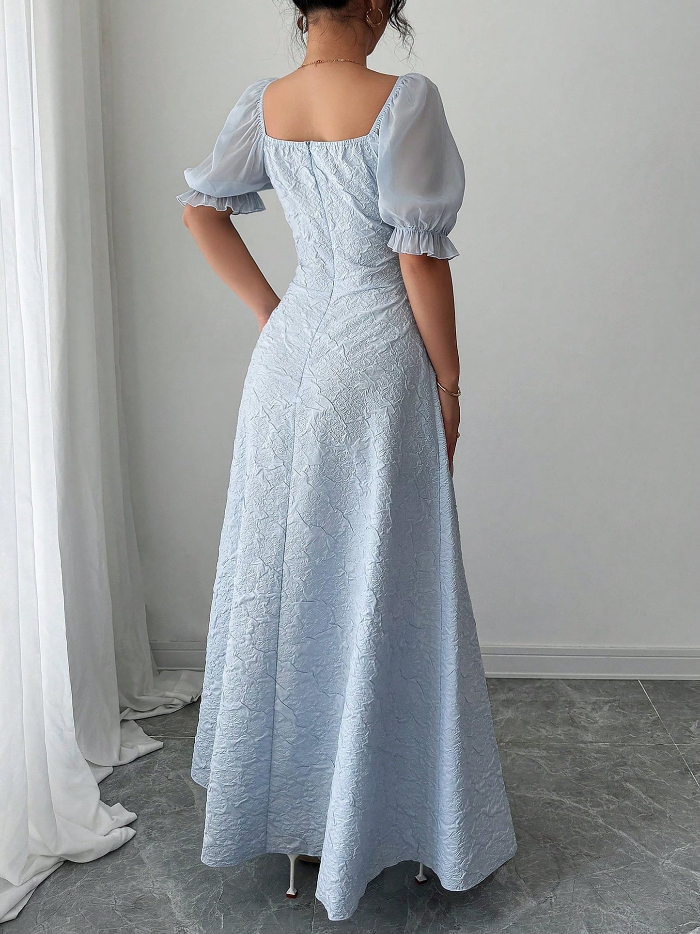 Grey Blue - Model wearing a textured jacquard A-line maxi dress with sheer puff sleeves and side lace-up bodice detailing.
