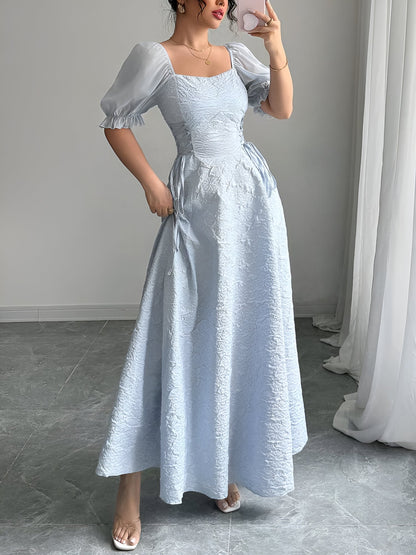 Grey Blue - Model wearing a textured jacquard A-line maxi dress with sheer puff sleeves and side lace-up bodice detailing.