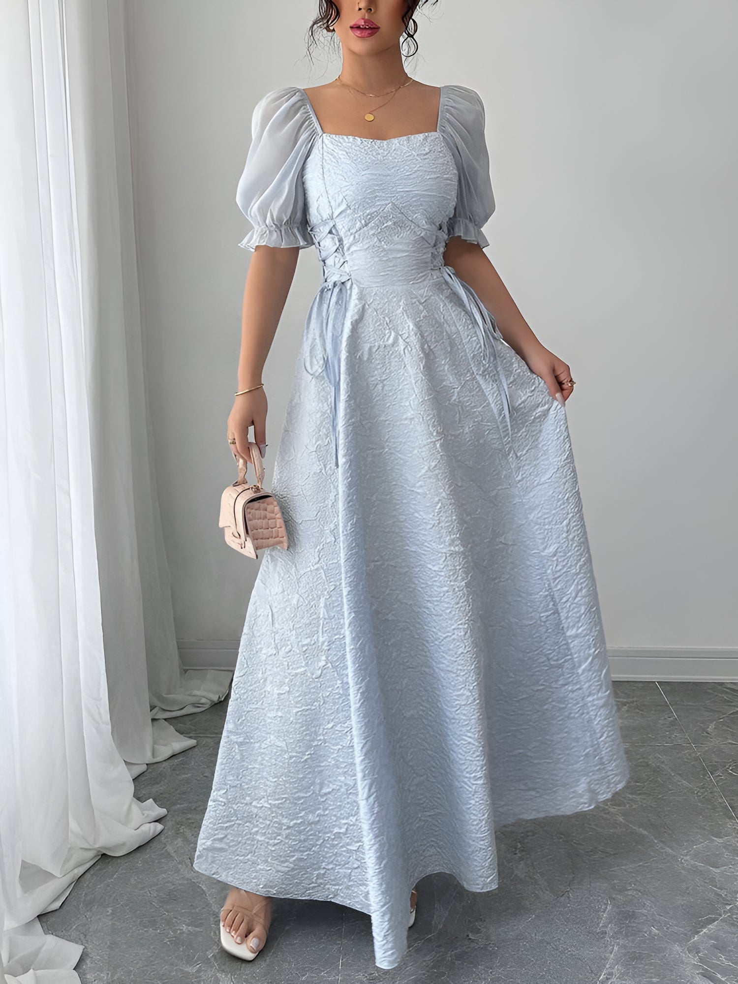 Grey Blue - Model wearing a textured jacquard A-line maxi dress with sheer puff sleeves and side lace-up bodice detailing.