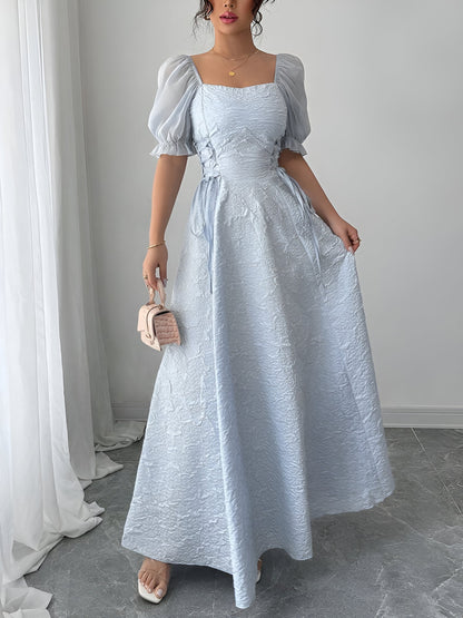 Grey Blue - Model wearing a textured jacquard A-line maxi dress with sheer puff sleeves and side lace-up bodice detailing.