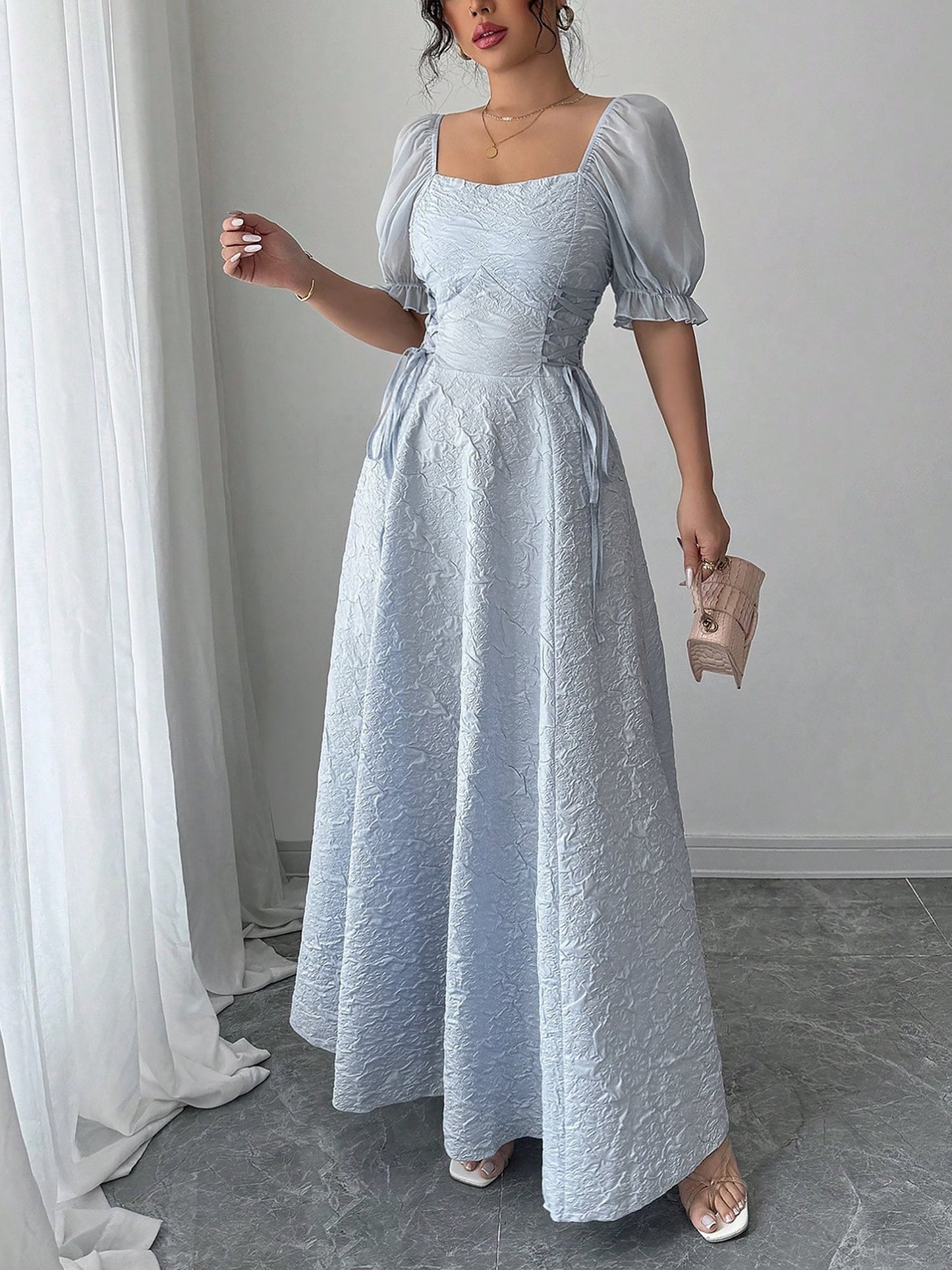Grey Blue - Model wearing a textured jacquard A-line maxi dress with sheer puff sleeves and side lace-up bodice detailing.