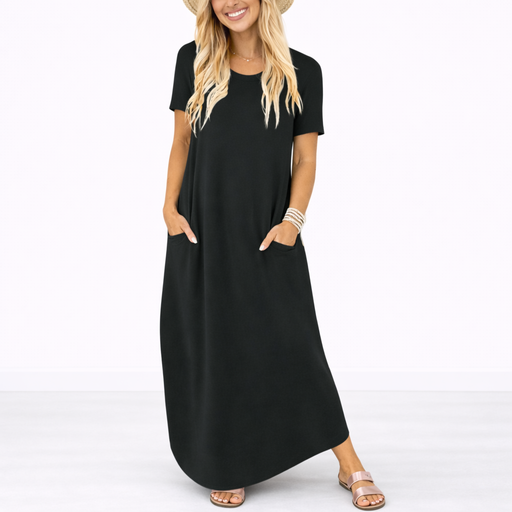 Black - Model wearing a striped short-sleeve maxi dress with a round neckline, side pockets, and a subtle side split, styled with trainers and a straw hat.