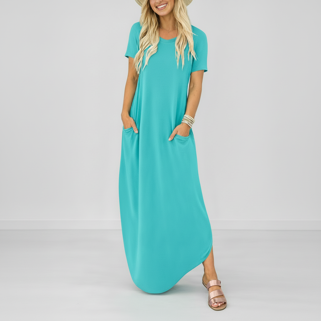 Light blue - Model wearing a striped short-sleeve maxi dress with a round neckline, side pockets, and a subtle side split, styled with trainers and a straw hat.