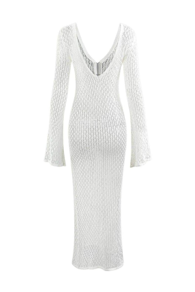 White - A woman wearing a white, semi-sheer crochet maxi dress with long flared sleeves and a deep V-neckline with keyhole detailing, standing outdoors.