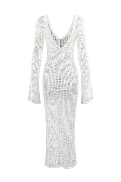 White - A woman wearing a white, semi-sheer crochet maxi dress with long flared sleeves and a deep V-neckline with keyhole detailing, standing outdoors.