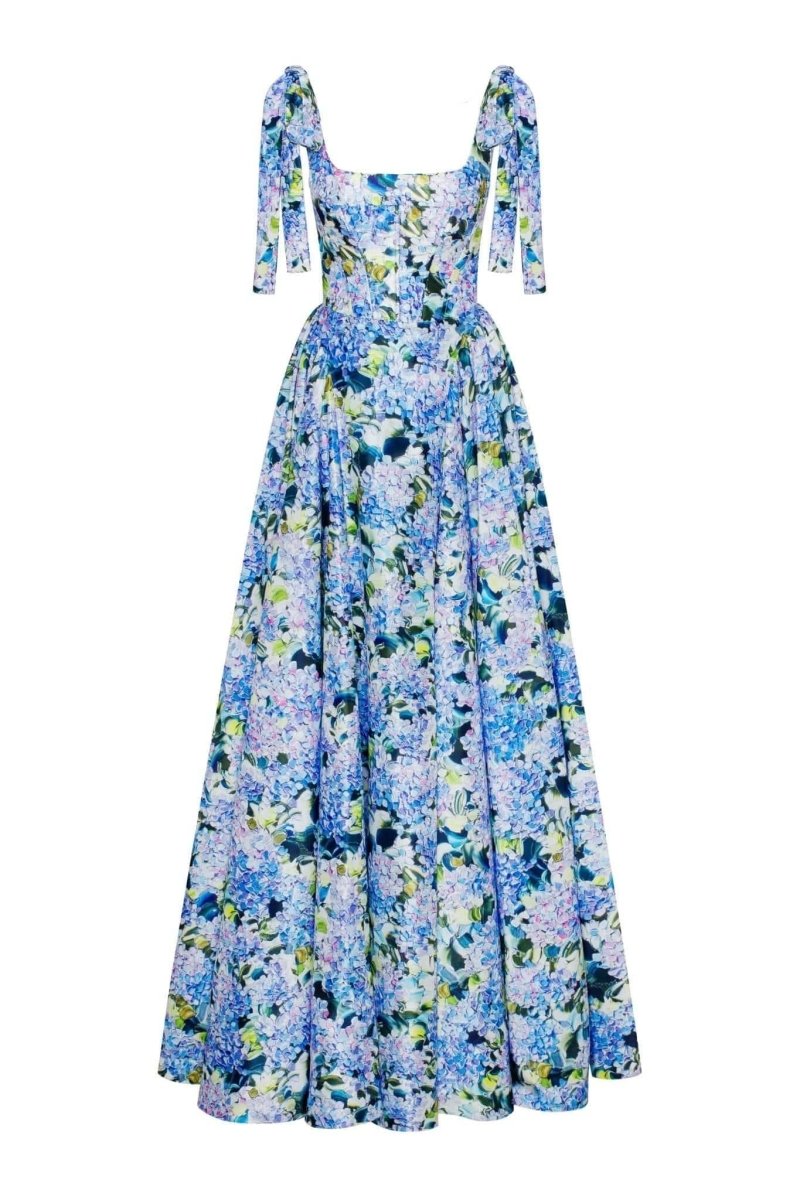 Blue - A woman models an elegant floor-length maxi dress featuring a structured corset bodice, tie-shoulder straps, and a vibrant blue and green floral print on a crisp, voluminous fabric.