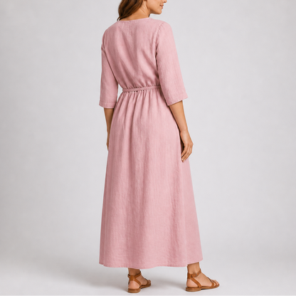 Pink - Woman wearing a relaxed woven midaxi dress with 3/4 sleeves, a tie waist, and a ruffled button-front bodice