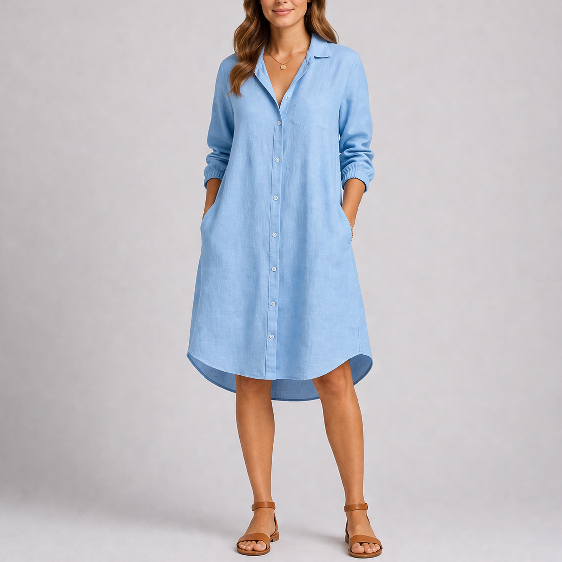 light blue - Woman modelling a relaxed fit, long-sleeve midi shirt dress featuring a collared neckline, button-down front, and side pockets.