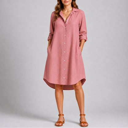 Pink - Woman modelling a relaxed fit, long-sleeve midi shirt dress featuring a collared neckline, button-down front, and side pockets.