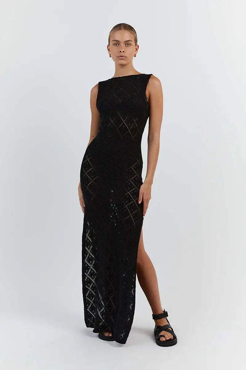 Black - A woman modelling a cream-coloured, sleeveless maxi dress featuring an intricate geometric open-knit pattern, a high neckline, and a high side slit.