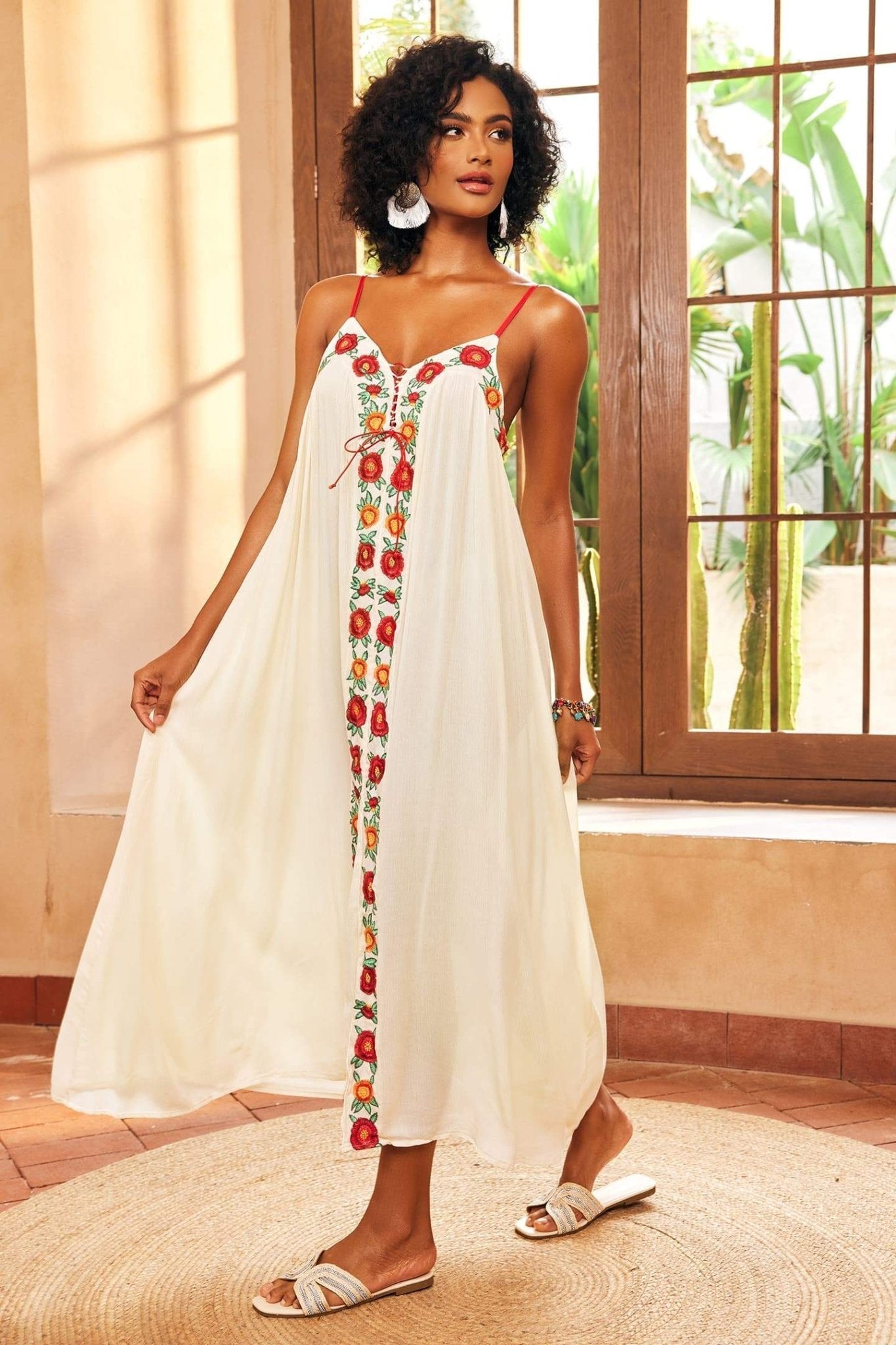 White - Women's cream maxi dress featuring delicate red spaghetti straps, a relaxed flowing silhouette, a vibrant central panel of red and orange floral embroidery, and a front slit.