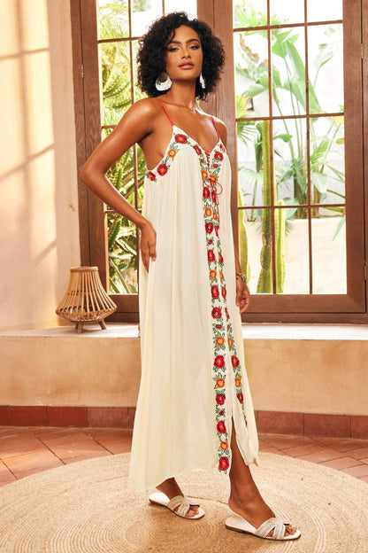 White - Women's cream maxi dress featuring delicate red spaghetti straps, a relaxed flowing silhouette, a vibrant central panel of red and orange floral embroidery, and a front slit.