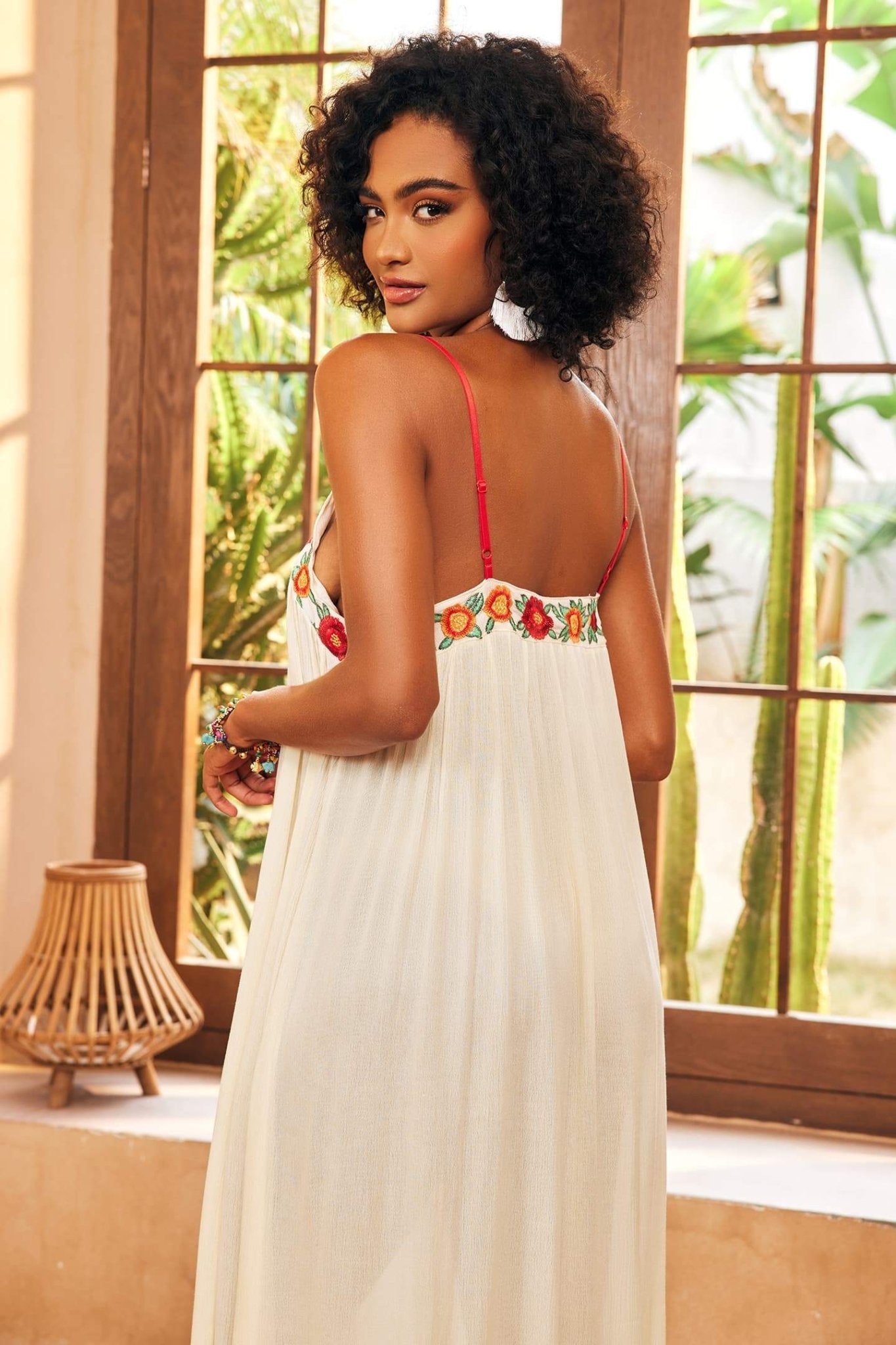 White - Women's cream maxi dress featuring delicate red spaghetti straps, a relaxed flowing silhouette, a vibrant central panel of red and orange floral embroidery, and a front slit.