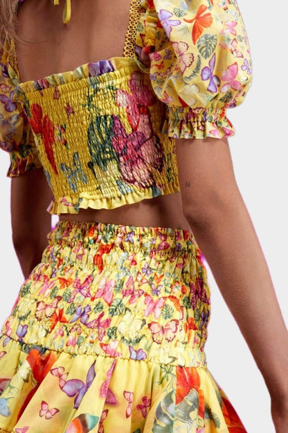 Yellow - Women's white cropped blouse featuring a colourful butterfly and botanical print, a shirred bodice, square neckline, and short puff sleeves, paired with a matching tiered mini skirt.