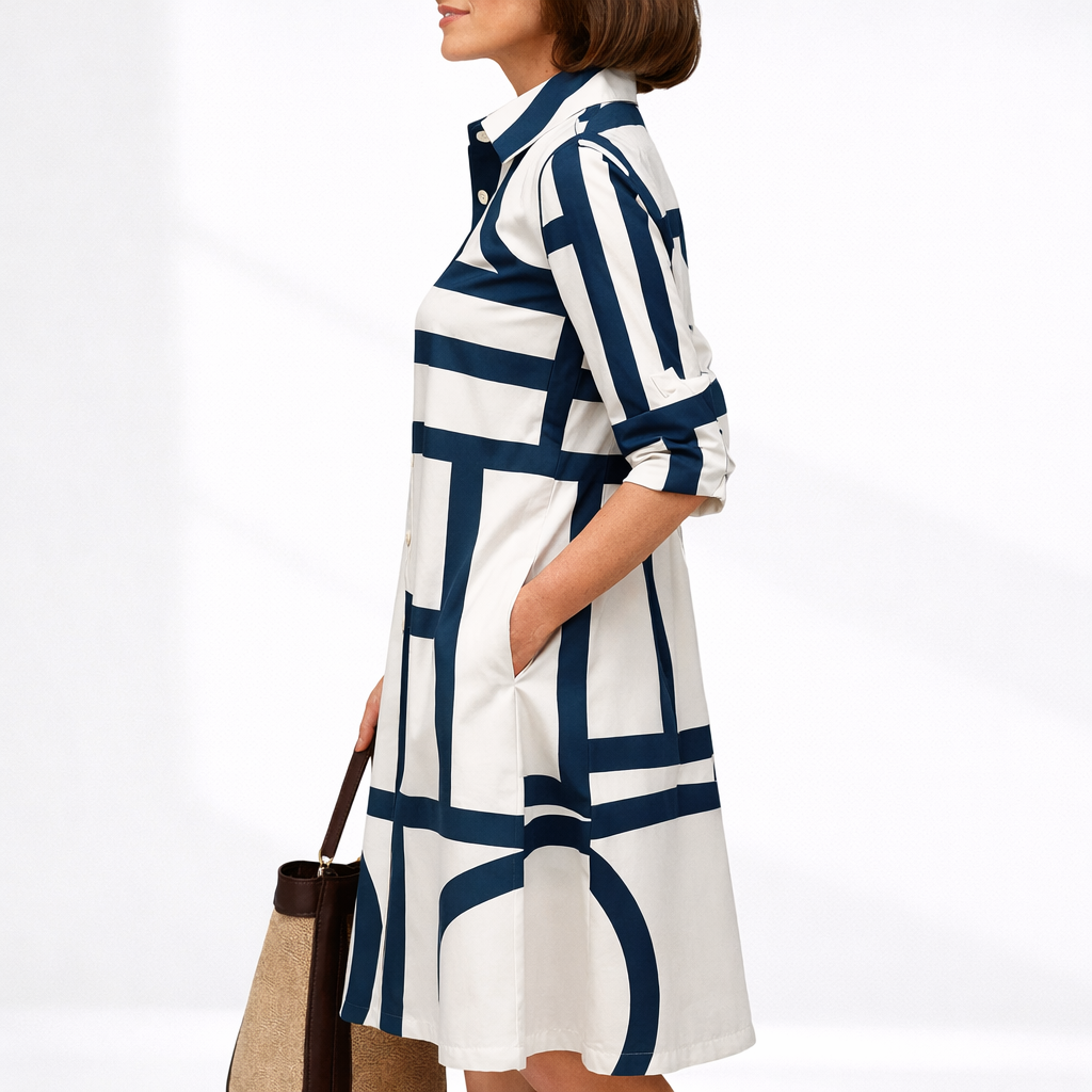 Blue & White - Woman wearing a geometric pattern poplin midi shirt dress with a collar, 3/4 sleeves, and button-down front.