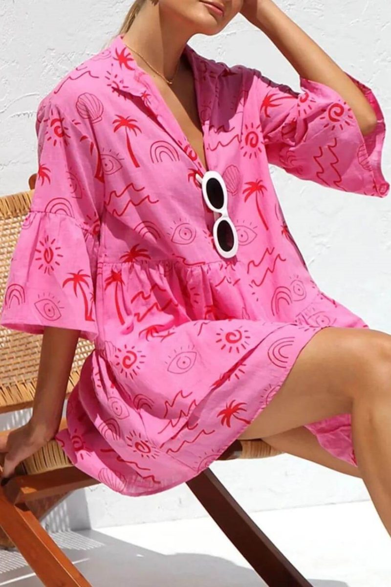 Pink - Women's light-coloured mini dress featuring a blue line-art print of suns and vases, styled with a V-neck collar, button front, wide half sleeves, and a voluminous tiered smock silhouette.
