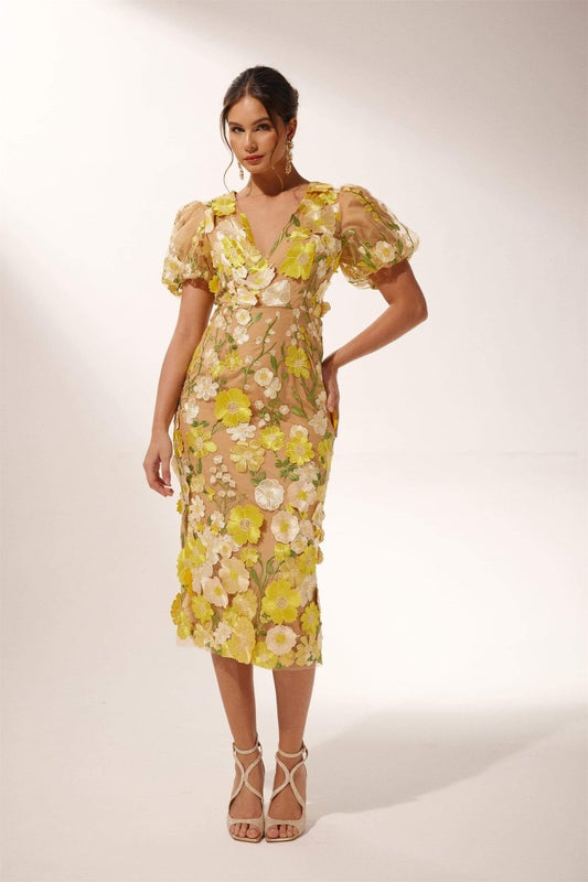 Yellow - Woman wearing a sheer midi dress with yellow and white 3D floral appliqué, puff sleeves, and a V-neckline.